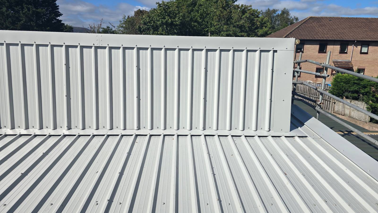 Close-up of the finished light grey metal cladding and roof sheets at Faith Church
