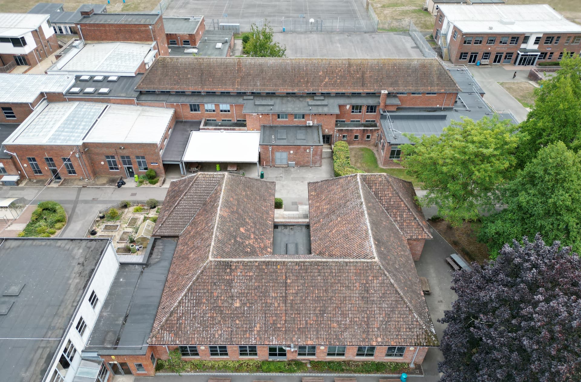 Failed metal roof covering on the second pitched block before works, Kingsbury Green Academy