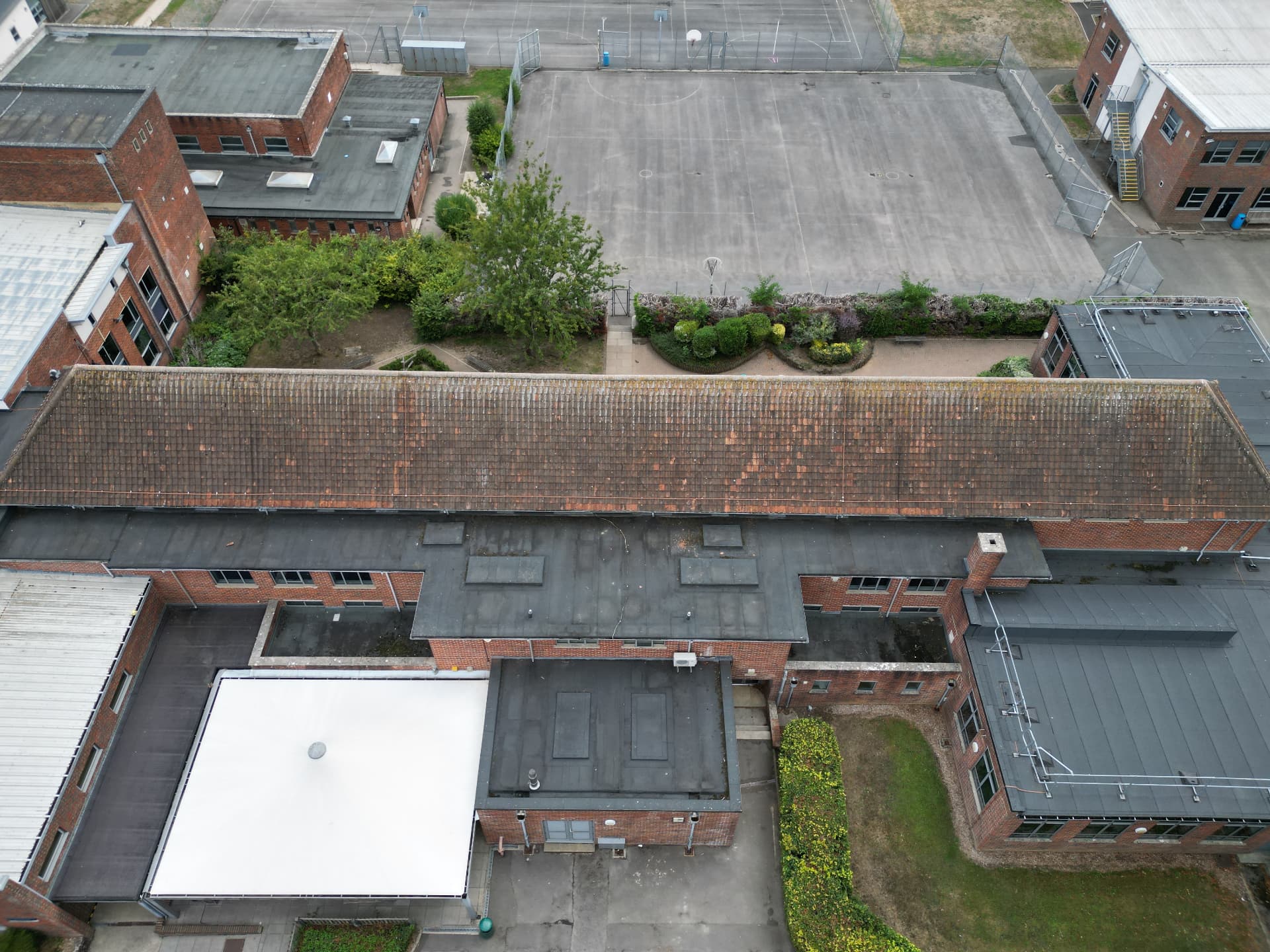 Long teaching block roof before replacement at Kingsbury Green Academy