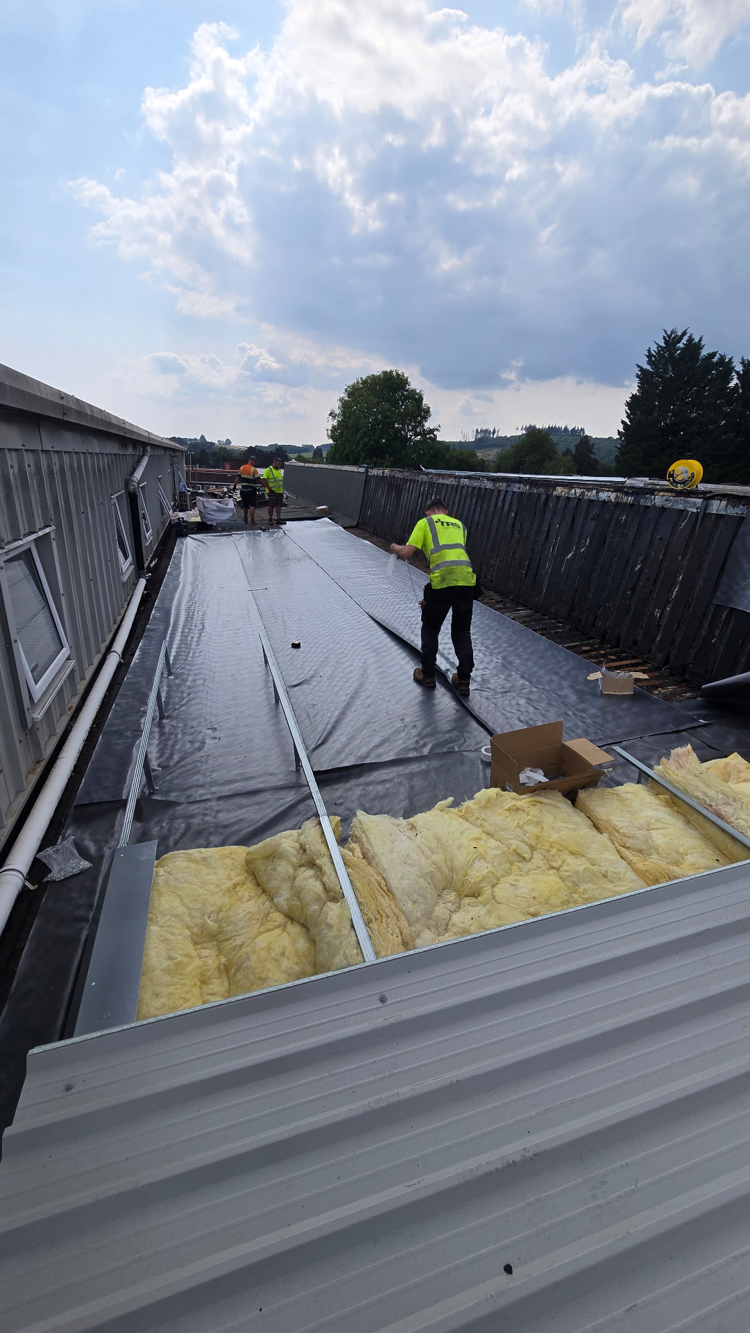 TRS operative laying insulation and membrane over the prepared roof deck at Faith Church