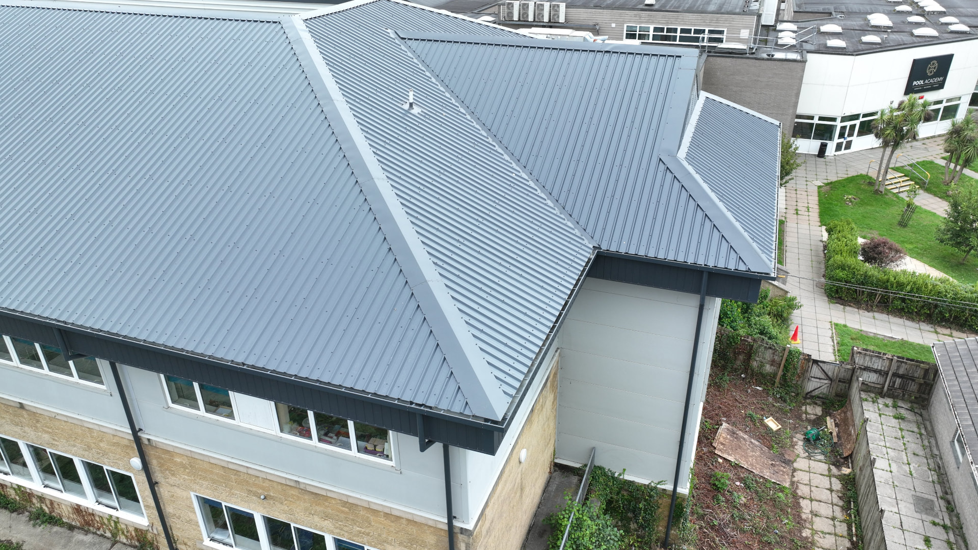 Completed grey overclad hips, eaves and fascia at Pool Academy