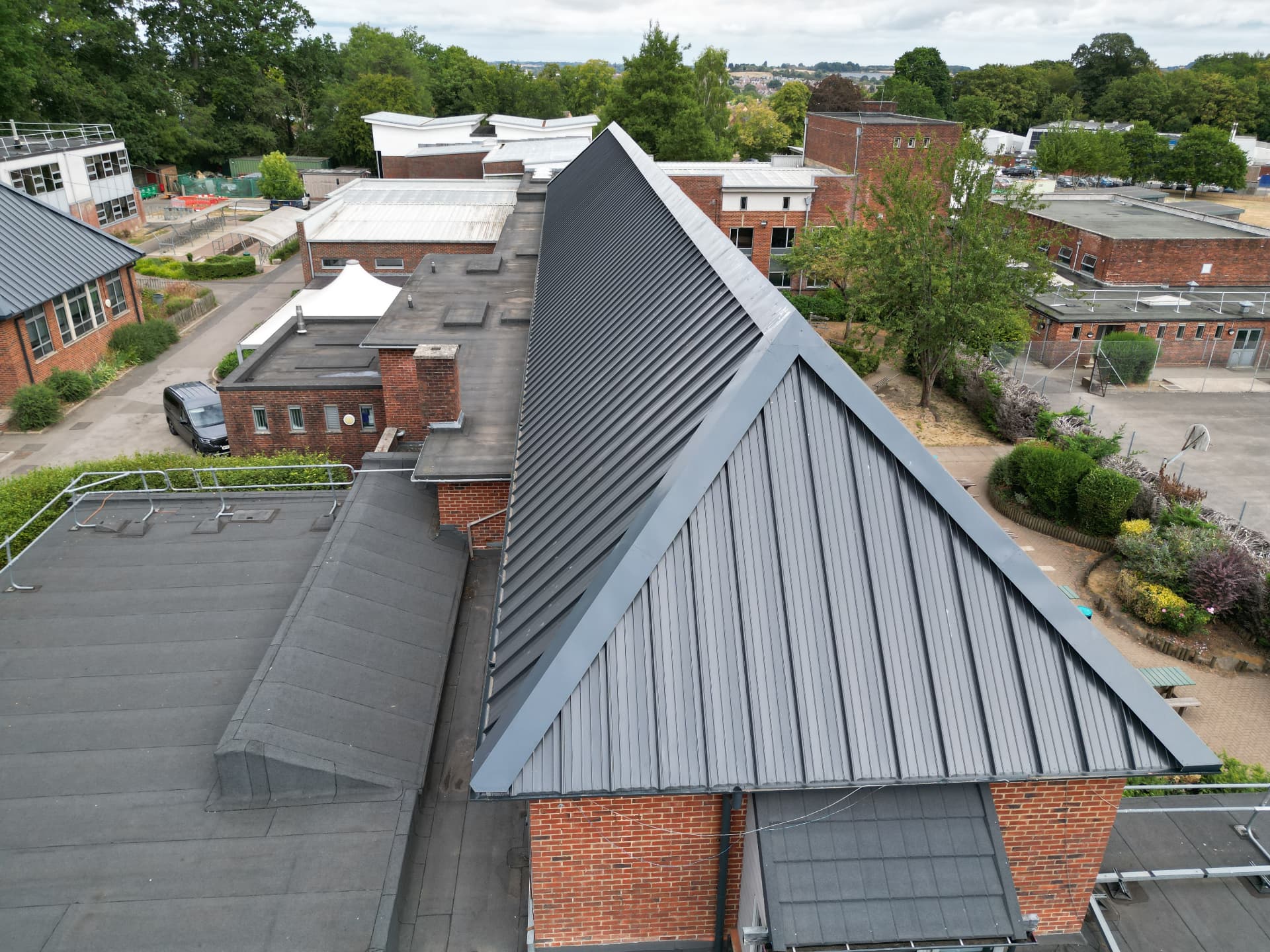 Side elevation showing completed high-pitch metal roof, Kingsbury Green Academy