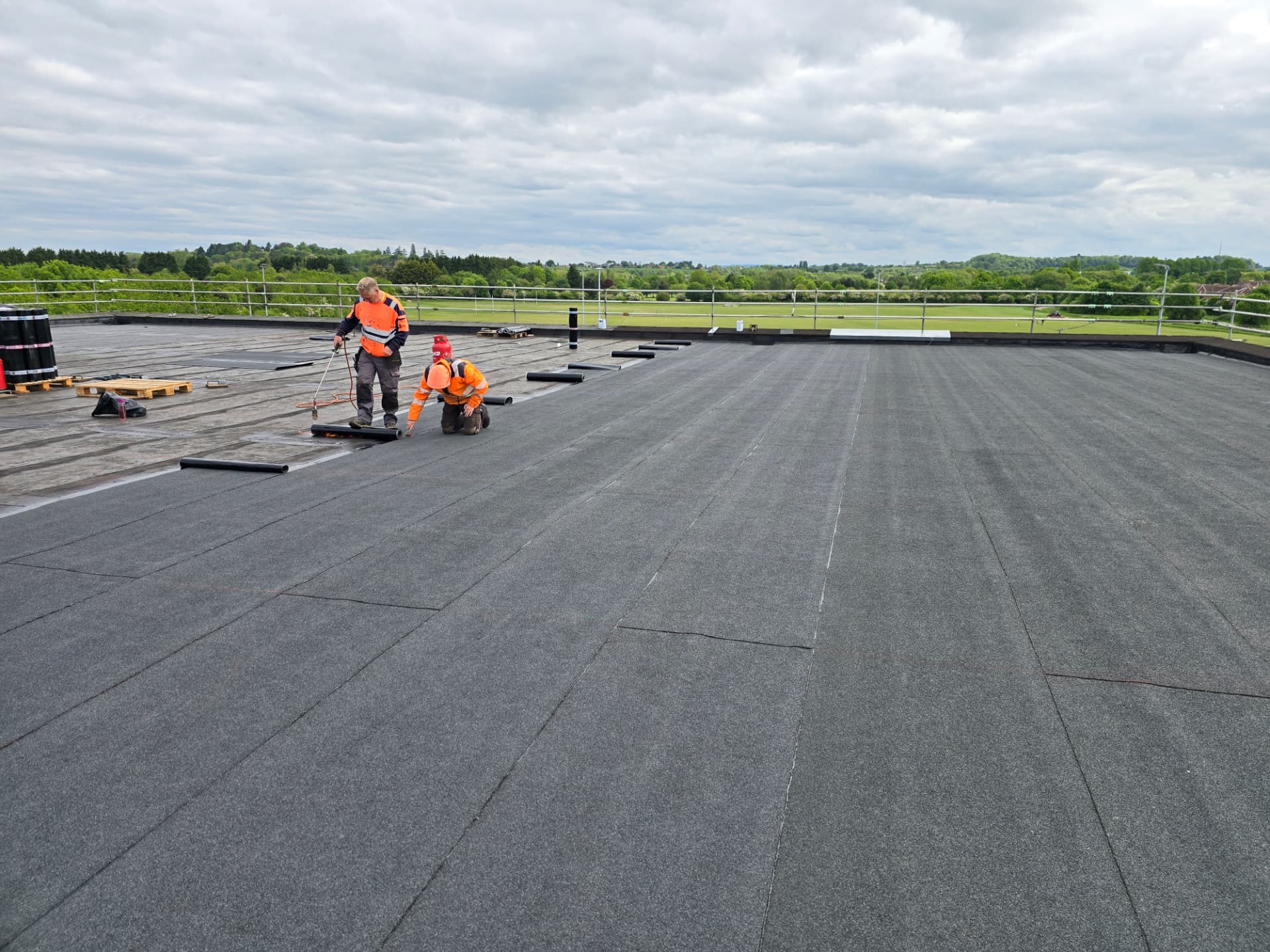 TRS operatives torch-on installing a bituminous membrane roof on a commercial building
