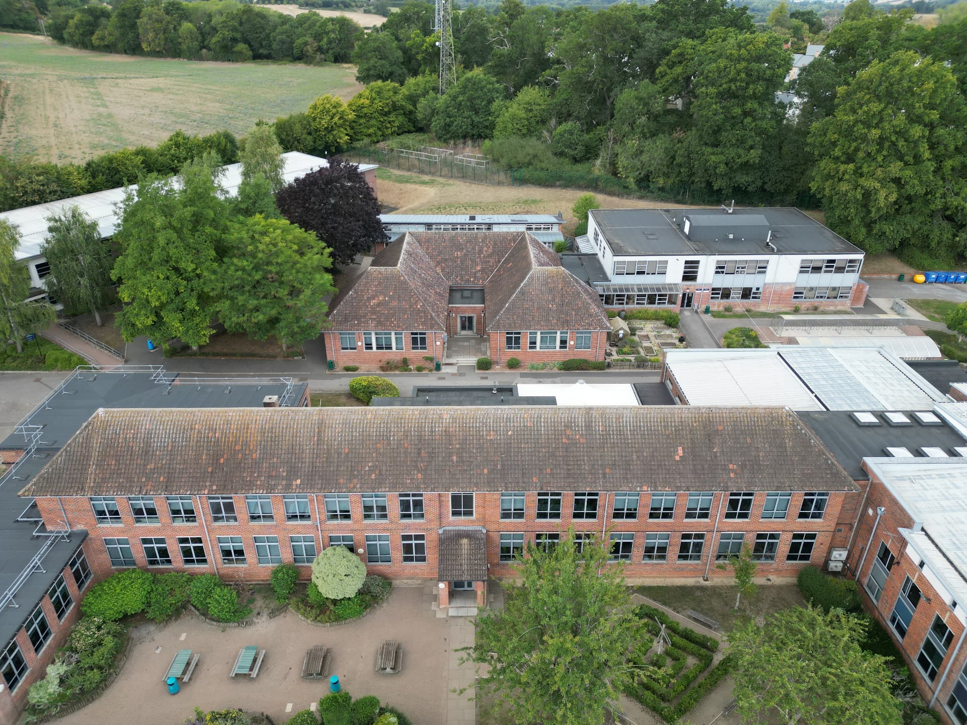 Corroded profiled metal pitched roof before replacement at Kingsbury Green Academy, Calne