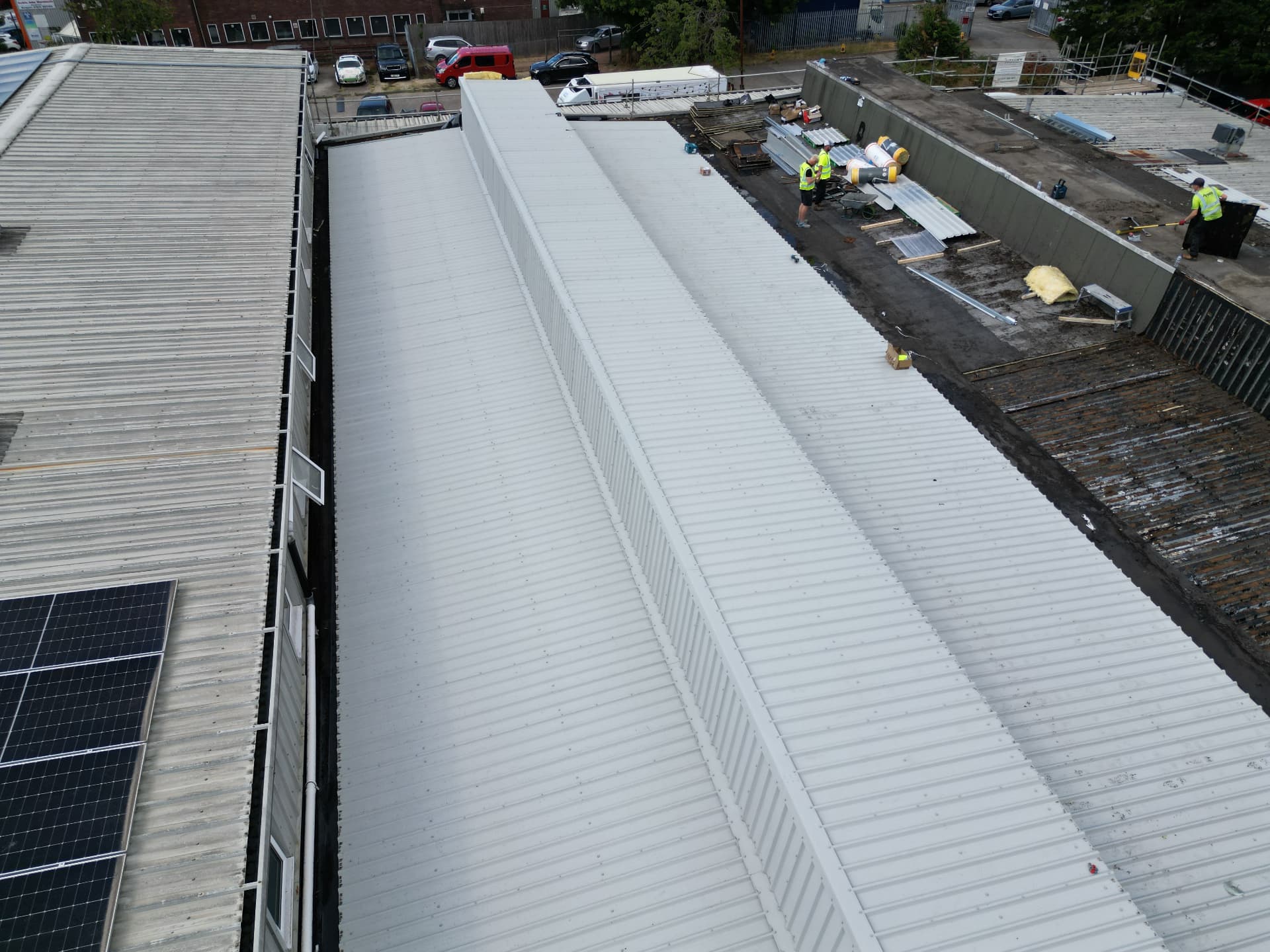 Aerial view along the new light grey metal roof spans at Faith Church, Newport