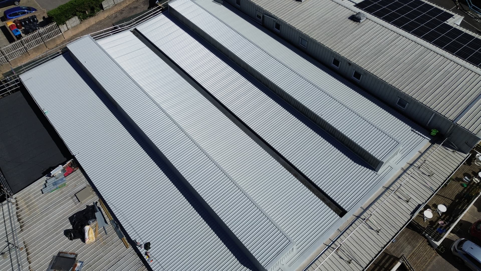 Aerial view of the completed light grey metal roof spans at Faith Church, Newport