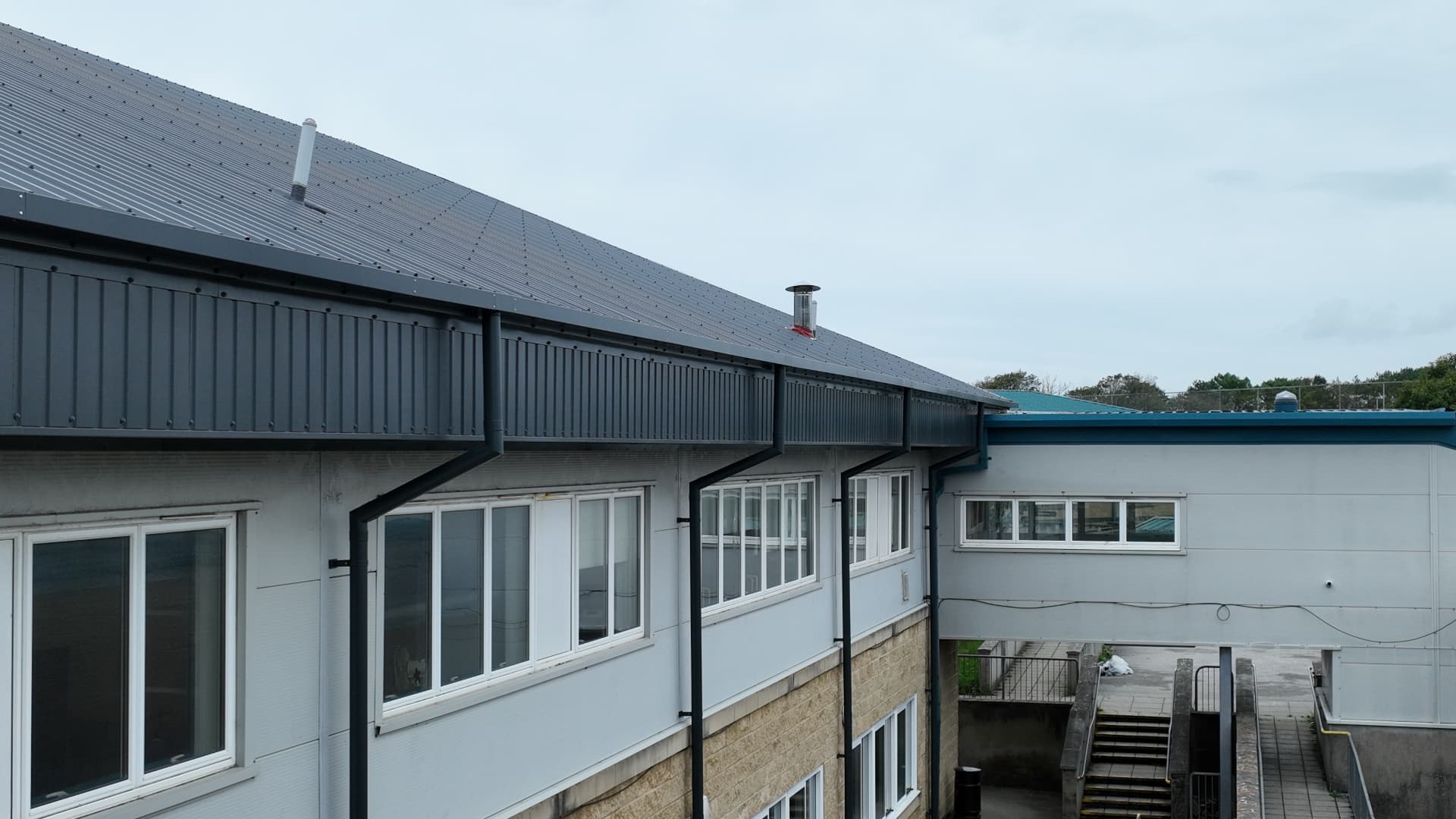 New fascia overcladding, guttering and downpipes at Pool Academy on completion