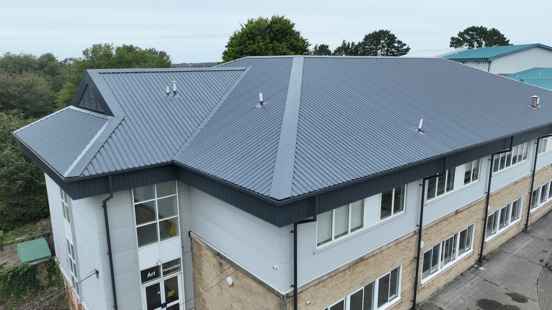 Completed grey metal overclad on the Art and Humanities block at Pool Academy